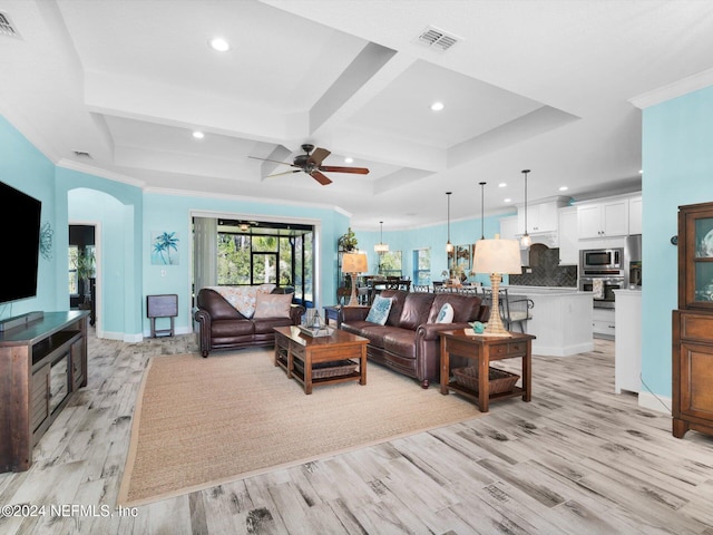 living room with light wood-type flooring, ornamental molding, coffered ceiling, ceiling fan, and beam ceiling