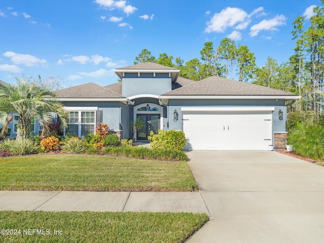 view of front of house with a front lawn and a garage