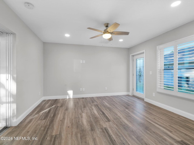 spare room featuring hardwood / wood-style floors and ceiling fan