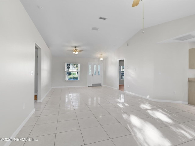 unfurnished living room with light tile patterned floors, vaulted ceiling, and ceiling fan