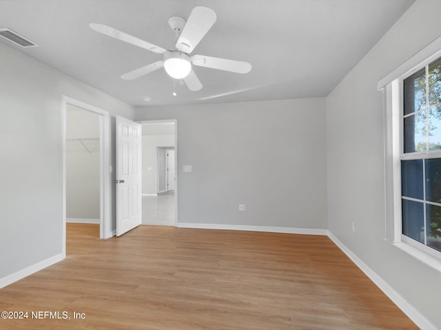 unfurnished room featuring ceiling fan and light wood-type flooring