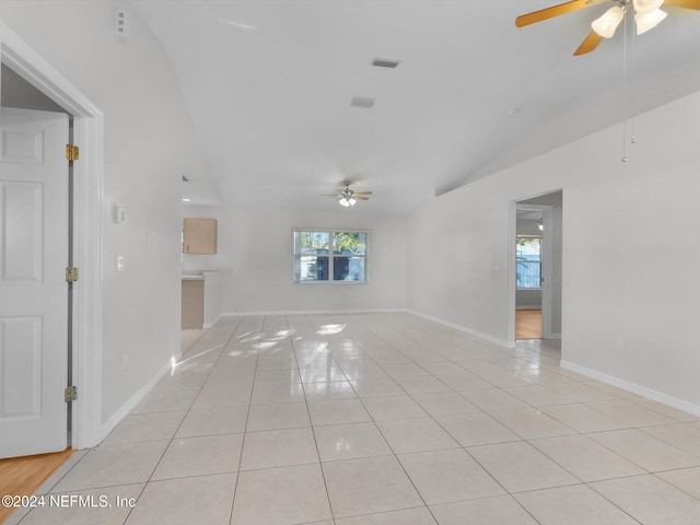 spare room featuring light tile patterned floors, ceiling fan, and lofted ceiling