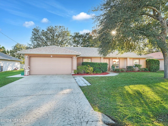 ranch-style home with a front yard and a garage