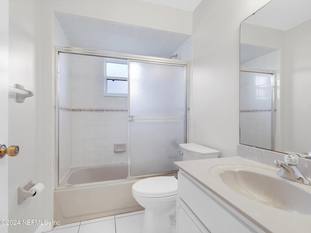 full bathroom with tile patterned flooring, vanity, enclosed tub / shower combo, and toilet