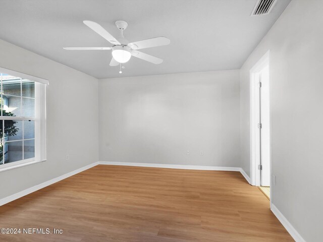 unfurnished room featuring hardwood / wood-style flooring and ceiling fan