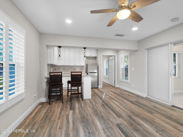 kitchen featuring stainless steel fridge and a wealth of natural light