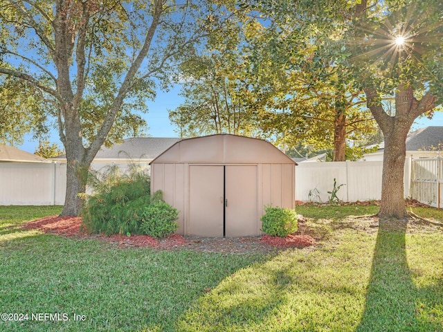 view of outdoor structure featuring a lawn