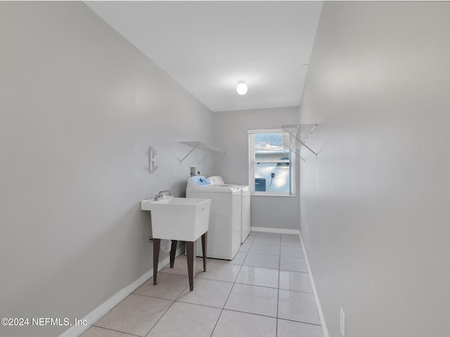 washroom featuring light tile patterned flooring and washer and dryer