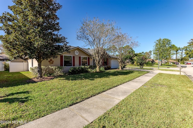 view of front of house featuring a garage and a front lawn