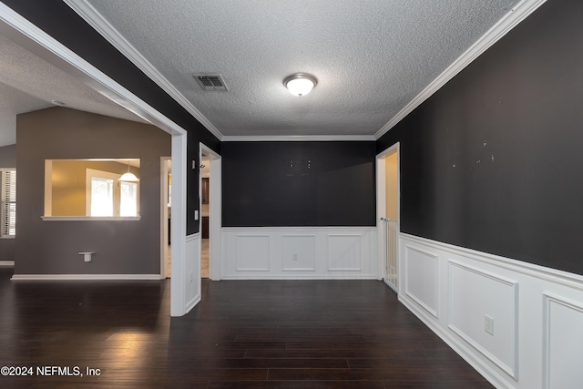 unfurnished room with a textured ceiling, lofted ceiling, ornamental molding, and dark wood-type flooring