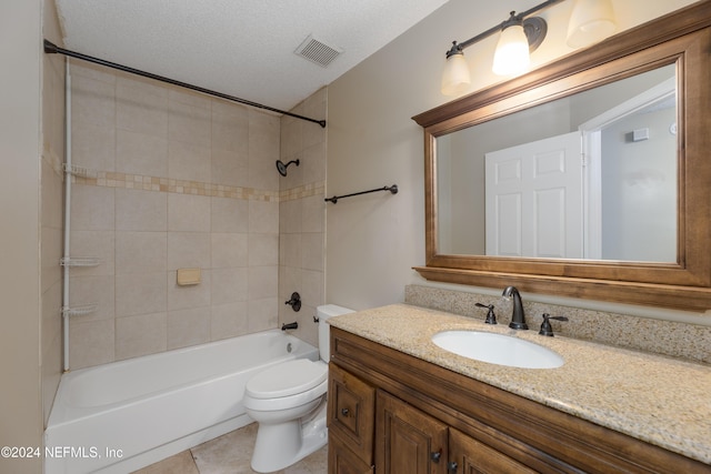 full bathroom with vanity, a textured ceiling, tile patterned flooring, toilet, and tiled shower / bath