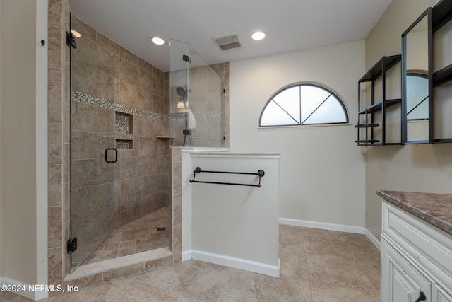 bathroom with vanity, tile patterned floors, and a shower with door