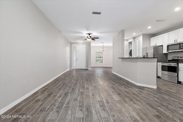 kitchen featuring ceiling fan, wood-type flooring, white cabinetry, and stainless steel appliances