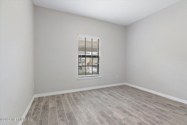 empty room with light hardwood / wood-style flooring