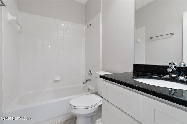 full bathroom with vanity, toilet, and tiled shower / bath