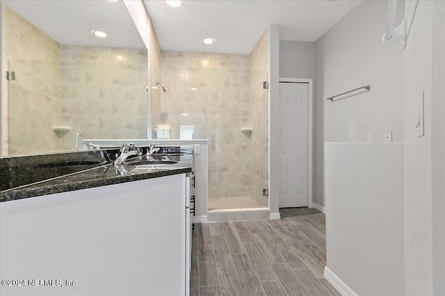 bathroom featuring vanity and a shower with door