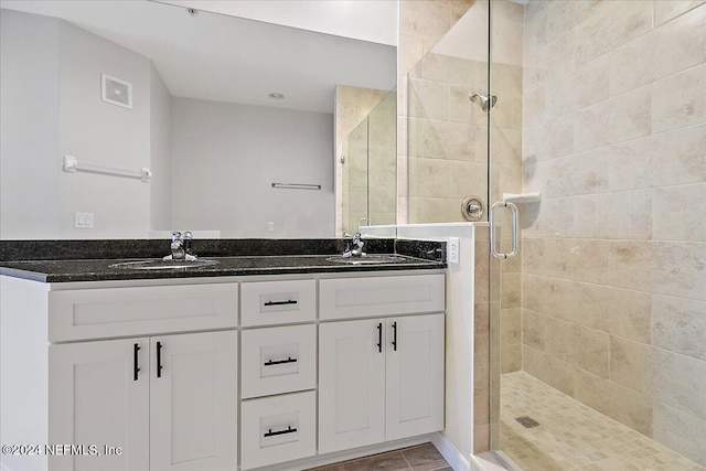 bathroom featuring vanity and an enclosed shower