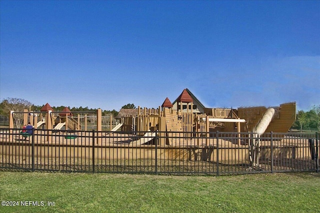 view of jungle gym featuring a lawn