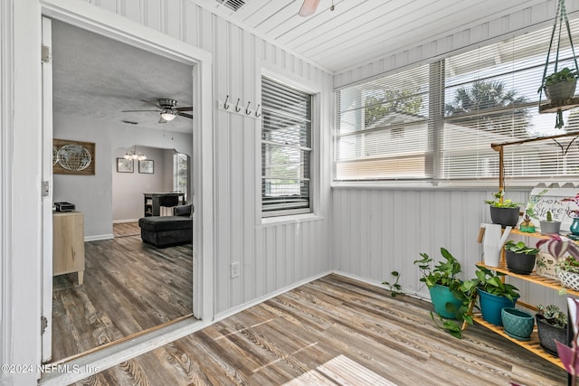 sunroom / solarium featuring ceiling fan