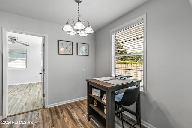 interior space with ceiling fan with notable chandelier and dark hardwood / wood-style flooring