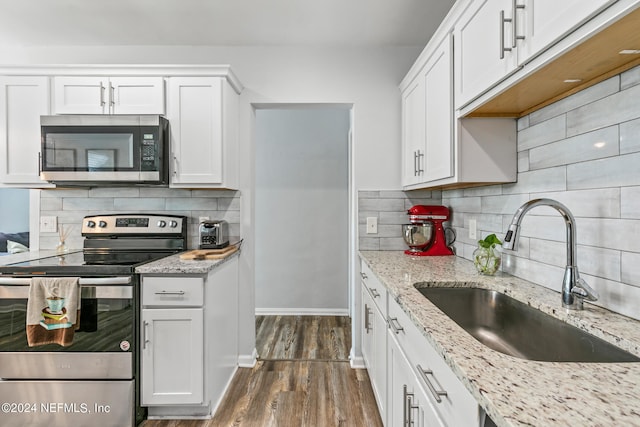 kitchen featuring white cabinetry, sink, tasteful backsplash, dark hardwood / wood-style floors, and appliances with stainless steel finishes