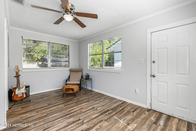 sitting room with dark hardwood / wood-style floors, ceiling fan, and ornamental molding