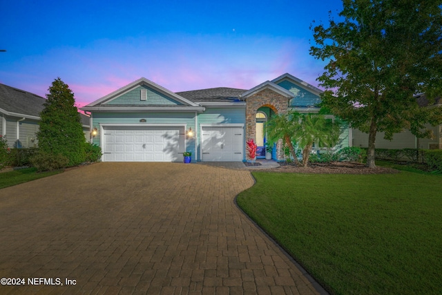 view of front of home featuring a yard and a garage