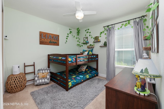 bedroom featuring light carpet and ceiling fan