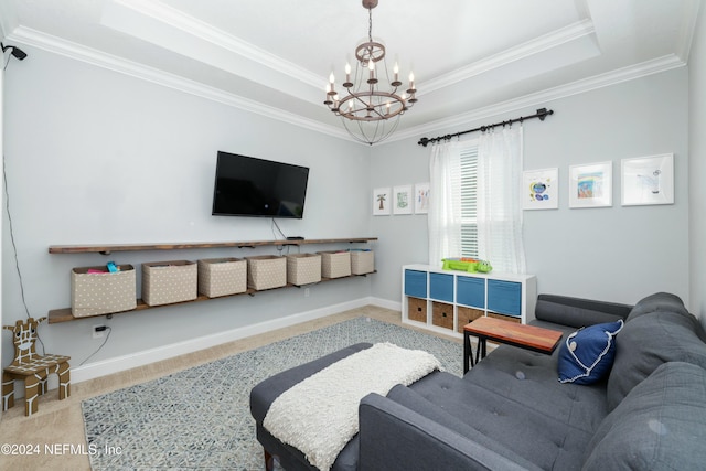 living room featuring a tray ceiling, crown molding, carpet floors, and an inviting chandelier