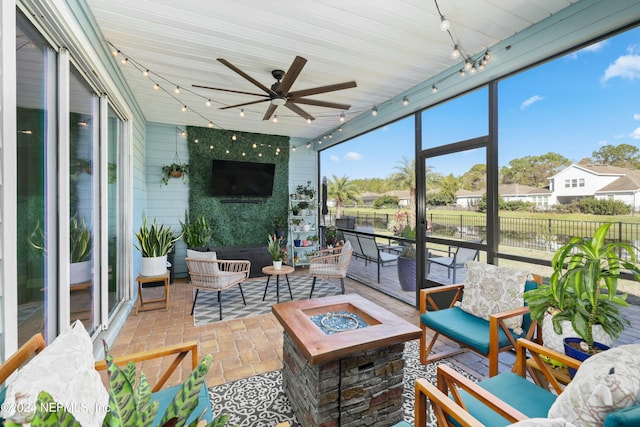 sunroom / solarium featuring ceiling fan and wooden ceiling