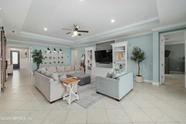 tiled living room featuring ceiling fan, crown molding, and a tray ceiling