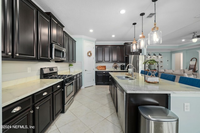 kitchen with pendant lighting, a spacious island, sink, a kitchen bar, and stainless steel appliances