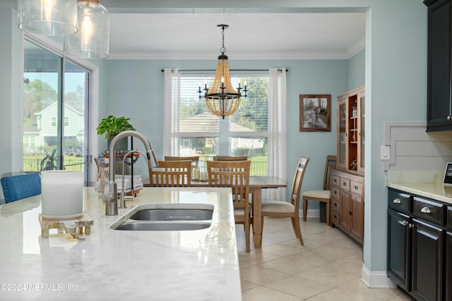 kitchen with sink, a notable chandelier, decorative light fixtures, light tile patterned floors, and ornamental molding