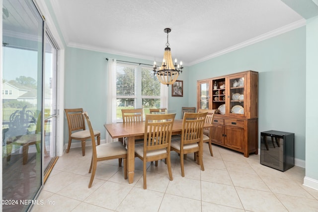 tiled dining space featuring ornamental molding, a textured ceiling, beverage cooler, and a chandelier