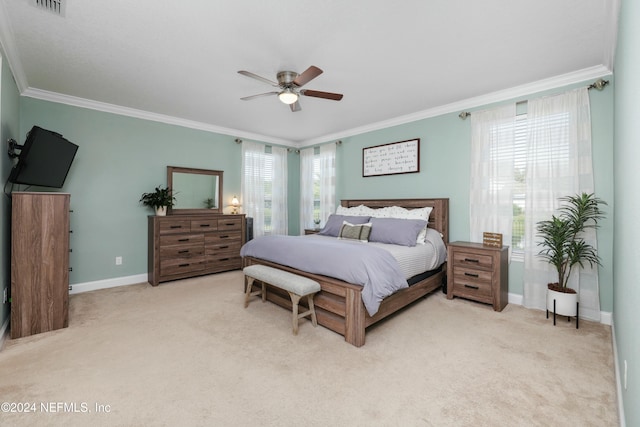 bedroom with ceiling fan, light carpet, and ornamental molding