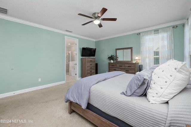 carpeted bedroom featuring ensuite bathroom, crown molding, and ceiling fan