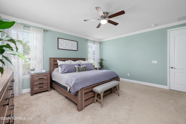 carpeted bedroom featuring a textured ceiling, ceiling fan, and crown molding