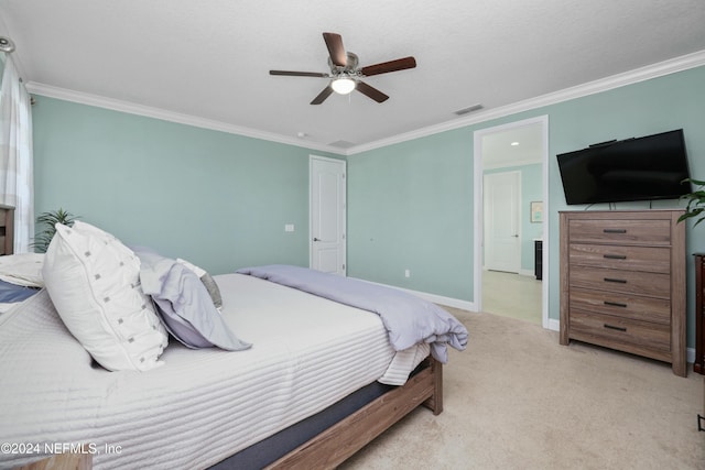 carpeted bedroom with ceiling fan and ornamental molding