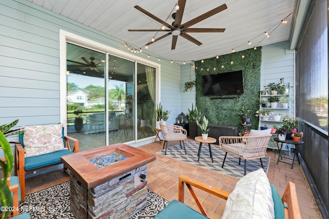 view of patio / terrace featuring ceiling fan and a fire pit