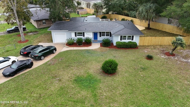 ranch-style home with a front yard and a garage