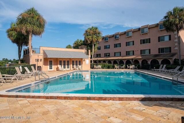 view of swimming pool with a patio area and french doors