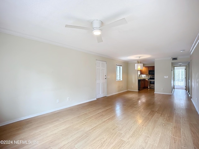 unfurnished living room featuring light hardwood / wood-style floors, plenty of natural light, and ornamental molding