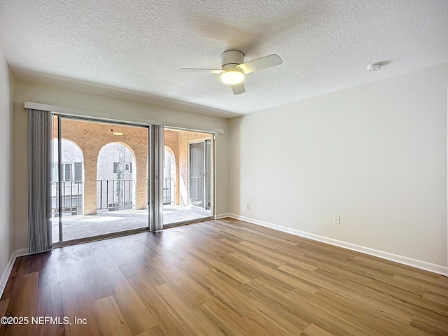 5375 Ortega Farms Blvd Unit 614, Jacksonville, FL 32210 - empty room with wood finished floors, baseboards, a ceiling fan, healthy amount of natural light, and a textured ceiling