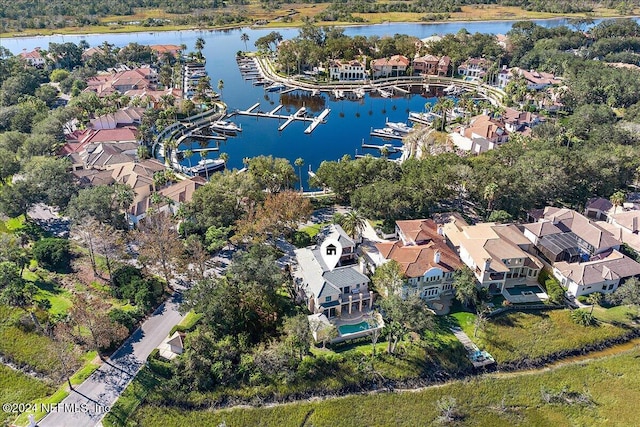 drone / aerial view with a water view and a residential view