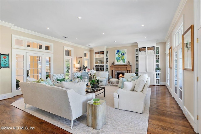 living room featuring recessed lighting, dark wood-style floors, a fireplace, and ornamental molding