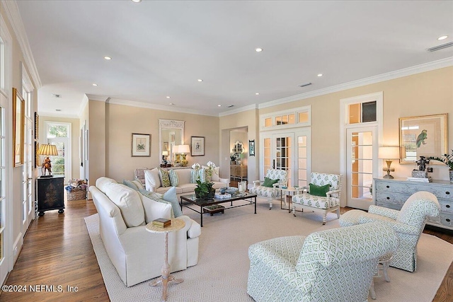 living area with visible vents, ornamental molding, wood finished floors, recessed lighting, and french doors