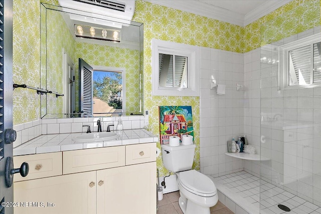 full bath with wallpapered walls, crown molding, toilet, tiled shower, and vanity