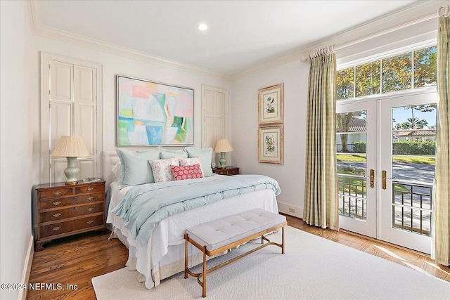 bedroom with access to exterior, crown molding, and french doors