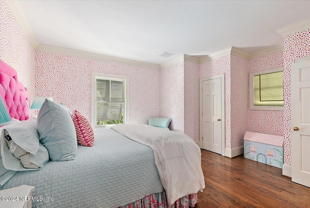 bedroom featuring wood finished floors, ornamental molding, and wallpapered walls