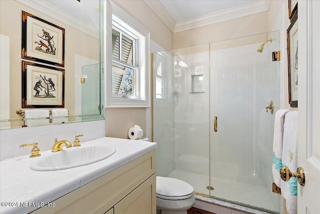 full bath with vanity, crown molding, toilet, and a shower stall